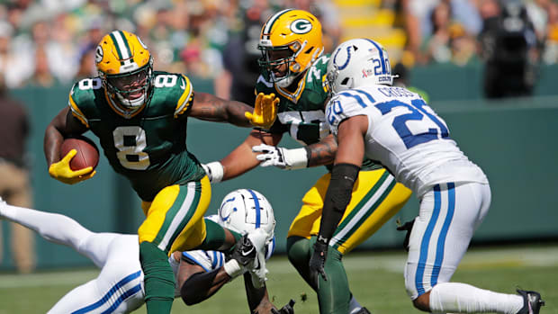 Green Bay Packers running back Josh Jacobs (8) runs for a first down against Indianapolis Colts safety Nick Cross