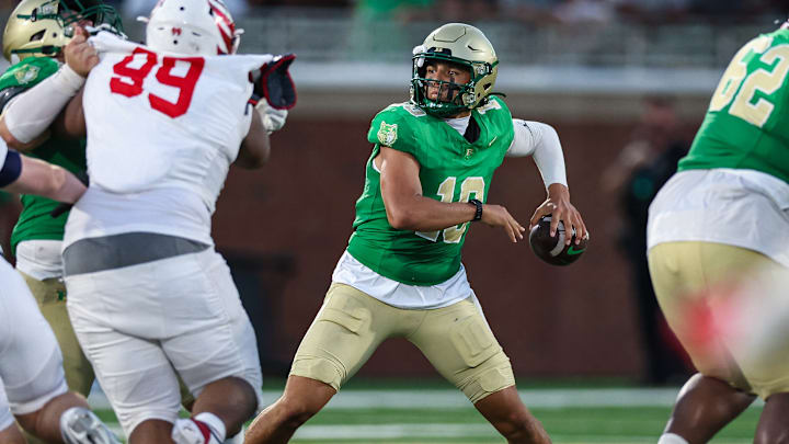 Buford quarterback Dayton Raiola (10) looks to pass as Milton's Christian Hunter applies the pass rush in the 2025 Georgia high school opener, won by 