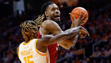 Arkansas Razorback post man Jonas Aidoo (right) is checked by Tennessee Volunteer guard Jahmai Mashack during Saturday's 76-52 Vol's win at Tompson Boling Arena in Knoxville.