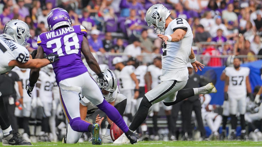 Aug 10, 2024; Minneapolis, Minnesota, USA; Las Vegas Raiders kicker Daniel Carlson kicks an extra point against the Minnesota Vikings in the second quarter at U.S. Bank Stadium. Mandatory Credit: Brad Rempel-USA TODAY Sports