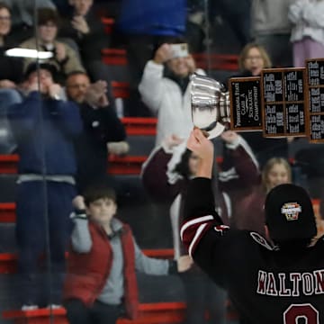 Garnet Valley forward Kevin Walton raises the Pennsylvania state hockey champion toward the Jaguars' faithful that made the 300-mile trip to see the Jaguars play Saturday at the RMU Island Sports Center. Walton scored twice in the 7-2 win.