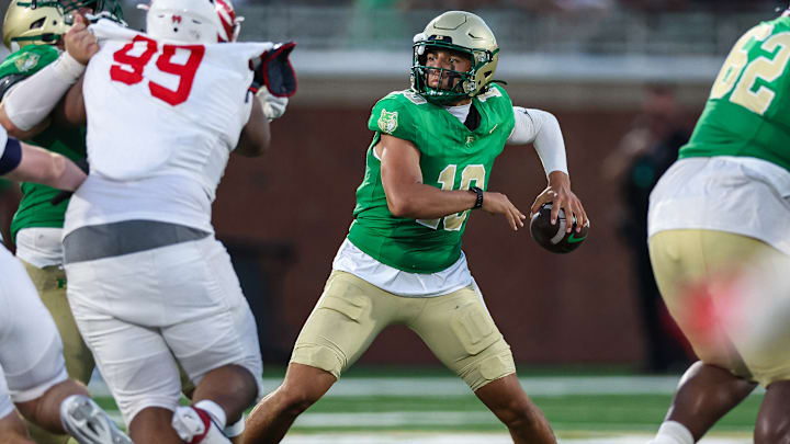 Buford quarterback Dayton Raiola (10) looks to pass as Milton's Christian Hunter applies the pass rush in the 2025 Georgia high school opener, won by Buford quarterback Dayton Raiola (10) looks to pass as Milton's Christian Hunter applies the pass rush in the 2025 Georgia high school opener, won by