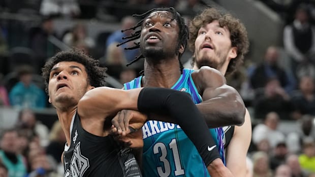Nathan Mensah battling for a rebound against the Spur