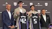 Maxime Raynaud and Nique Cliffard hold up their Sacramento Kings jerseys at their introductory press conference