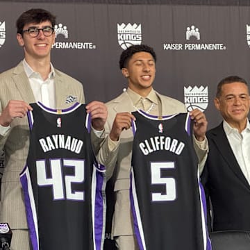 Maxime Raynaud and Nique Cliffard hold up their Sacramento Kings jerseys at their introductory press conference