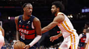 Nov 25, 2025; Washington, District of Columbia, USA; Washington Wizards center Alex Sarr (20) holds the ball as Atlanta Hawks forward Jacob Toppin (0) defends in the second half at Capital One Arena. Mandatory Credit: Geoff Burke-Imagn Images