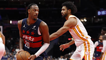 Nov 25, 2025; Washington, District of Columbia, USA; Washington Wizards center Alex Sarr (20) holds the ball as Atlanta Hawks forward Jacob Toppin (0) defends in the second half at Capital One Arena. Mandatory Credit: Geoff Burke-Imagn Images