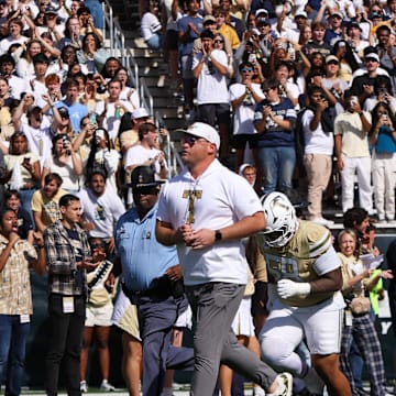 Oct 25, 2025; Atlanta, Georgia, USA; Georgia Tech Yellow Jackets head coach Brent Key runs with his team on the field before a game against the Syracuse Orange at Bobby Dodd Stadium at Hyundai Field. Mandatory Credit: Brett Davis-Imagn Images
