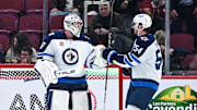 Jan 28, 2025; Montreal, Quebec, CAN; Winnipeg Jets goalie Connor Hellebuyck (37) and defenseman Dylan Samberg (54) celebrate the win against the Montreal Canadiens during the third period at Bell Centre. Mandatory Credit: David Kirouac-Imagn Images