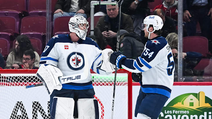 Jan 28, 2025; Montreal, Quebec, CAN; Winnipeg Jets goalie Connor Hellebuyck (37) and defenseman Dylan Samberg (54) celebrate the win against the Montreal Canadiens during the third period at Bell Centre. Mandatory Credit: David Kirouac-Imagn Images