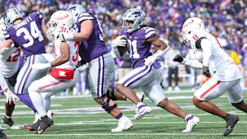 Oct 28, 2023; Manhattan, Kansas, USA; Kansas State Wildcats running back DJ Giddens (31) runs away from Houston Cougars linebacker Malik Robinson (8) during the third quarter at Bill Snyder Family Football Stadium. Mandatory Credit: Scott Sewell-USA TODAY Sports