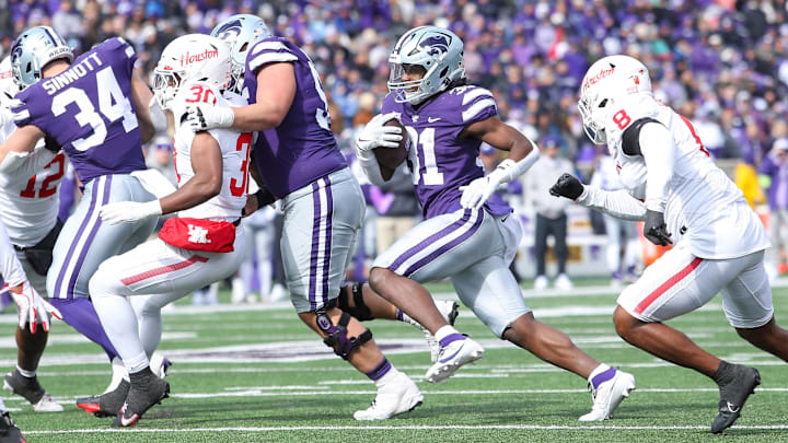 Oct 28, 2023; Manhattan, Kansas, USA; Kansas State Wildcats running back DJ Giddens (31) runs away from Houston Cougars linebacker Malik Robinson (8) during the third quarter at Bill Snyder Family Football Stadium. Mandatory Credit: Scott Sewell-USA TODAY Sports