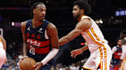 Nov 25, 2025; Washington, District of Columbia, USA; Washington Wizards center Alex Sarr (20) holds the ball as Atlanta Hawks forward Jacob Toppin (0) defends in the second half at Capital One Arena. Mandatory Credit: Geoff Burke-Imagn Images