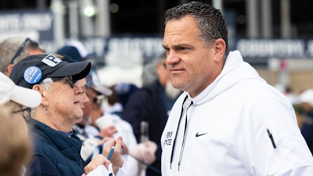 Penn State Athletic Director Pat Kraft talks with members of an alumni group outside of Beaver Stadium.