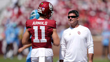 Oklahoma offensive coordinator Seth Littrell talks with quarterback Jackson Arnold (11) before a college football game between the University of Oklahoma Sooners (OU) and the Tulane Green Wave at Gaylord Family - Oklahoma Memorial Stadium in Norman, Okla., Saturday, Sept. 14, 2024.