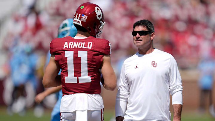 Oklahoma offensive coordinator Seth Littrell talks with quarterback Jackson Arnold (11) before a college football game between the University of Oklahoma Sooners (OU) and the Tulane Green Wave at Gaylord Family - Oklahoma Memorial Stadium in Norman, Okla., Saturday, Sept. 14, 2024.