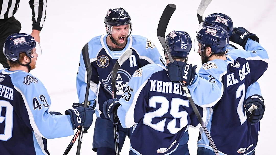 Teammates including Cal O'Reilly (16) surround Milwaukee Admirals right wing Joakim Kemell (25) to celebrate his goal against the Coachella Valley Firebirds in the first period of Game 4 of their AHL playoff series Thursday, June 6, 2024, at the UW-Milwaukee Panther Arena in Milwaukee, Wisconsin.