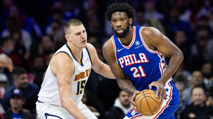 Philadelphia 76ers center Joel Embiid (21) controls the ball against Denver Nuggets center Nikola Jokic (15) during the first quarter at Wells Fargo Center. Mandatory Credit: