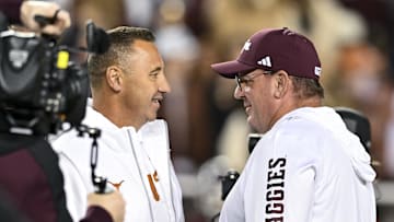Nov 30, 2024; College Station, Texas, USA; Texas Longhorns head coach Steve Sarkisian, left, and Texas A&M Aggies head coach Mike Elko, right, speak prior to the game at Kyle Field. Mandatory Credit: Maria Lysaker-Imagn Images 