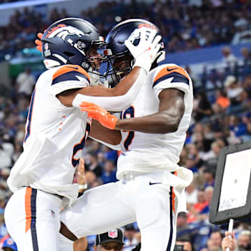 Aug 11, 2024; Indianapolis, Indiana, USA; Denver Broncos wide receiver Marvin Mims Jr. (19) and wide receiver Devaughn Vele (81) celebrate a touchdown during the second quarter against the Indianapolis Colts at Lucas Oil Stadium. 