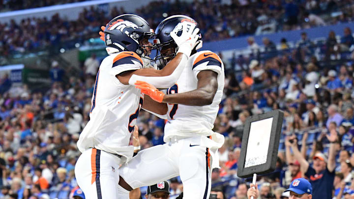 Aug 11, 2024; Indianapolis, Indiana, USA; Denver Broncos wide receiver Marvin Mims Jr. (19) and wide receiver Devaughn Vele (81) celebrate a touchdown during the second quarter against the Indianapolis Colts at Lucas Oil Stadium. 