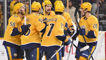 Oct 28, 2025; Nashville, Tennessee, USA;  Nashville Predators left wing Filip Forsberg (9) celebrates with his teammates after scoring a goal against the Tampa Bay Lightning during the third period at Bridgestone Arena. Mandatory Credit: Steve Roberts-Imagn Images