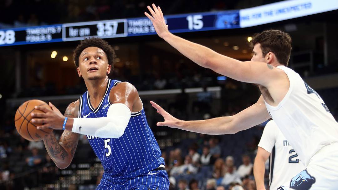 Oct 7, 2026; Memphis, Tennessee, USA;  Orlando Magic forward Paolo Banchero (5) handles the ball as Memphis Grizzlies center Quinten Post (41) defends during the second quarter at FedExForum.  Mandatory Credit: Petre Thomas-Imagn Images