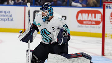 Feb 23, 2025; Tampa, Florida, USA; Seattle Kraken goaltender Ales Stezka (30) makes a save against the Tampa Bay Lightning in the first period at Amalie Arena. Mandatory Credit: Nathan Ray Seebeck-Imagn Images
