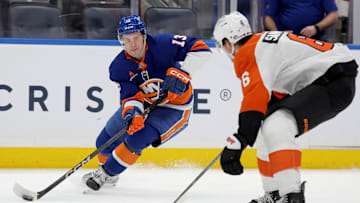 Jan 24, 2025; Elmont, New York, USA; New York Islanders center Mathew Barzal (13) controls the puck against Philadelphia Flyers defenseman Travis Sanheim (6) during the second period at UBS Arena. 