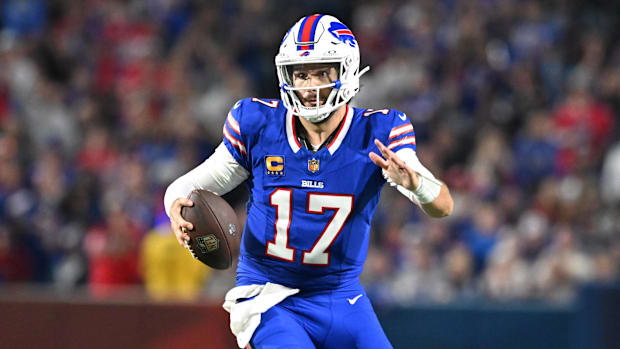 Josh Allen runs with the ball. 