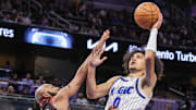 Dec 1, 2025; Orlando, Florida, USA; Orlando Magic guard Anthony Black (0) shoots against Chicago Bulls guard Jevon Carter (5) during the second quarter at Kia Center. Mandatory Credit: Mike Watters-Imagn Images
