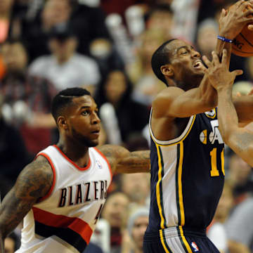 Dec 6, 2013; Portland, OR, USA; Utah Jazz point guard Alec Burks (10) and Portland Trail Blazers point guard Earl Watson (17) battle for a loose ball during the fourth quarter of the game at the Moda Center. The Blazers won the game 130-98. Mandatory Credit: Steve Dykes-Imagn Images