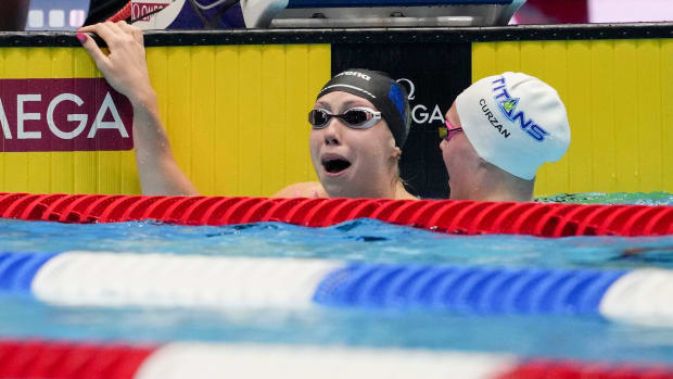 Gretchen Walsh reacts after setting a world record during the 100 meter butterfly semifinals at the U.S. Olympic Trials.
