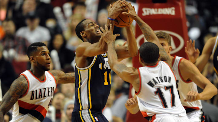 Dec 6, 2013; Portland, OR, USA; Utah Jazz point guard Alec Burks (10) and Portland Trail Blazers point guard Earl Watson (17) battle for a loose ball during the fourth quarter of the game at the Moda Center. The Blazers won the game 130-98. Mandatory Credit: Steve Dykes-Imagn Images