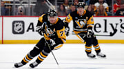Oct 10, 2023; Pittsburgh, Pennsylvania, USA;  Pittsburgh Penguins center Evgeni Malkin (71) skates with the puck along with center Sidney Crosby (87) against the Chicago Blackhawks during the first period at the PPG Paints Arena. Mandatory Credit: Charles LeClaire-Imagn Images