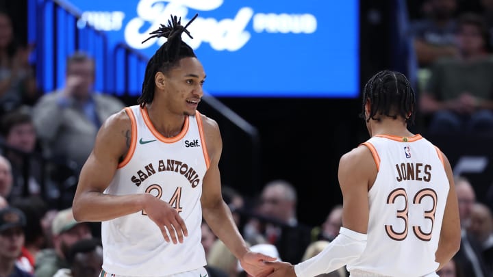 Feb 25, 2024; Salt Lake City, Utah, USA; San Antonio Spurs guard Devin Vassell (24) and guard Tre Jones (33) slaps hands after a play against the Utah Jazz during the second quarter at Delta Center. 