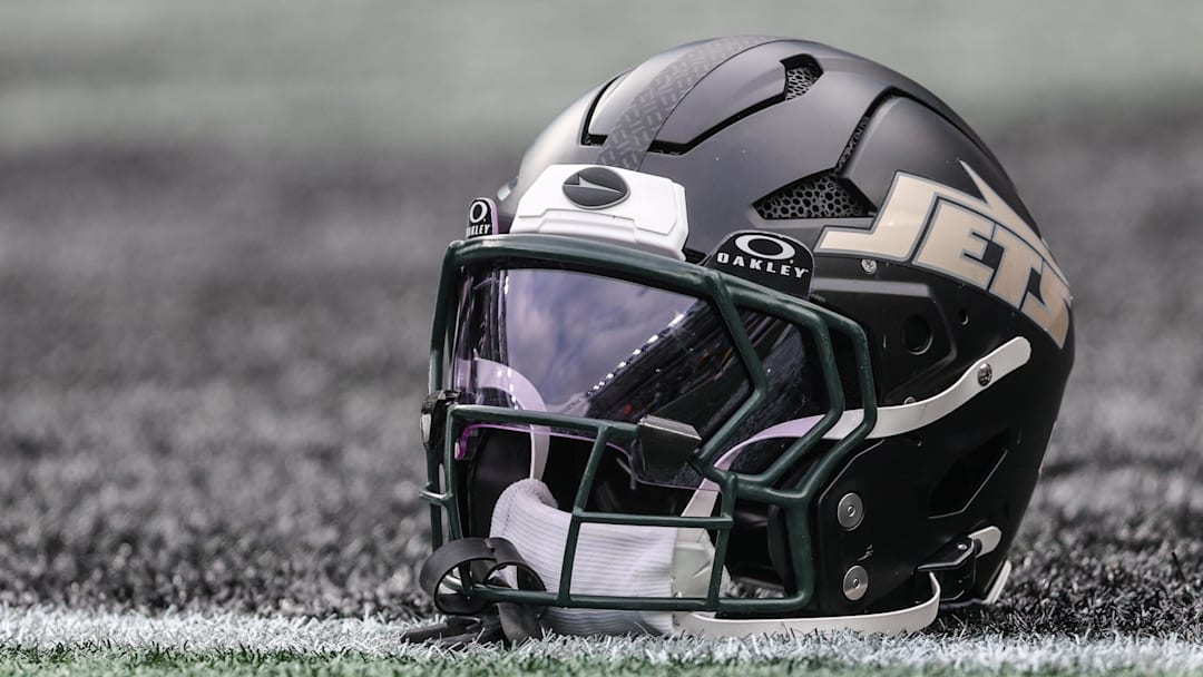Dec 7, 2025; East Rutherford, New Jersey, USA; A general view of a Gotham City football rivalries helmet resting on the field before the game against the Miami Dolphins at MetLife Stadium. Mandatory Credit: Vincent Carchietta-Imagn Images