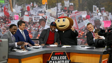 Lee Corso gives the thumbs up after picking Ohio State to win while, from left, Desmond Howard, Rece Davis, Archie Griffin, and Kirk Herbstreit sit on the set of ESPN's College GameDay broadcast from the campus of Ohio State prior to the NCAA football game against the Michigan State Spartans in Columbus on Nov. 21, 2015. (Adam Cairns / The Columbus Dispatch)