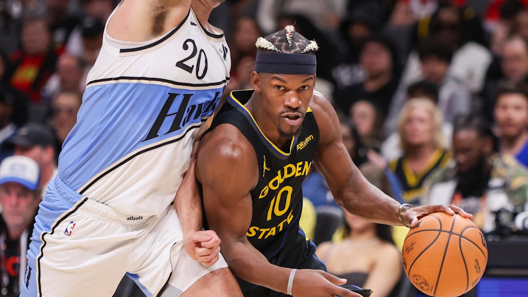 Mar 22, 2025; Atlanta, Georgia, USA; Golden State Warriors forward Jimmy Butler III (10) drives on Atlanta Hawks forward Georges Niang (20) in the fourth quarter at State Farm Arena. Mandatory Credit: Brett Davis-Imagn Images