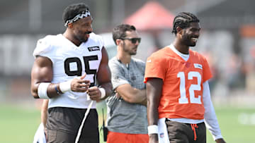 Jul 26, 2025; Berea, OH, USA; Cleveland Browns defensive end Myles Garrett (95) talks to quarterback Shedeur Sanders (12) during training camp at CrossCountry Mortgage Campus. Mandatory Credit: Ken Blaze-Imagn Images