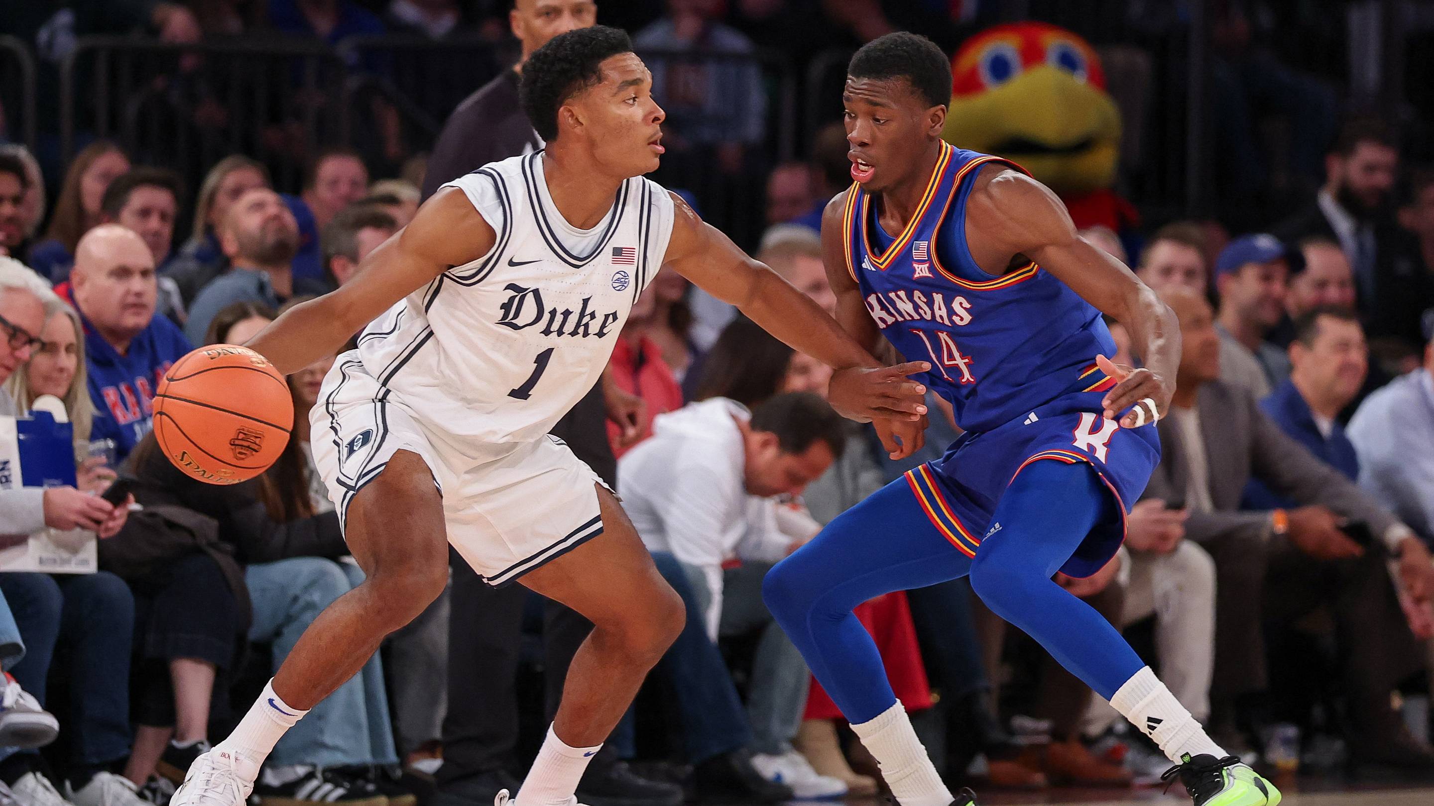 Nov 18, 2025; New York, New York, USA; Duke Blue Devils guard Caleb Foster (1) is guarded by Kansas Jayhawks guard Melvin Council Jr. (14) during the first half at Madison Square Garden. Mandatory Credit: Vincent Carchietta-Imagn Images | IMAGN IMAGES via Reuters Connect