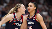 Apr 6, 2025; Tampa, FL, USA; Connecticut Huskies guard Paige Bueckers (5) reacts with teammates guard Ashlynn Shade (12) and guard Azzi Fudd (35) during the second half against the South Carolina Gamecocks of the national championship of the women's 2025 NCAA tournament at Amalie Arena. Mandatory Credit: Nathan Ray Seebeck-Imagn Images