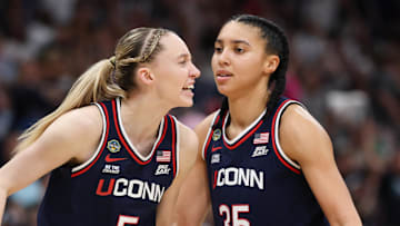 Apr 6, 2025; Tampa, FL, USA; Connecticut Huskies guard Paige Bueckers (5) reacts with teammates guard Ashlynn Shade (12) and guard Azzi Fudd (35) during the second half against the South Carolina Gamecocks of the national championship of the women's 2025 NCAA tournament at Amalie Arena. Mandatory Credit: Nathan Ray Seebeck-Imagn Images