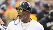 Nov 8, 2025; Morgantown, West Virginia, USA; Colorado Buffaloes head coach Deion Sanders walks along the sidelines late in the fourth quarter against the West Virginia Mountaineers at Milan Puskar Stadium.