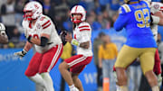 Nebraska Cornhuskers quarterback TJ Lateef (14) drops back to pass against the UCLA Bruins during the second half at the Rose Bowl.