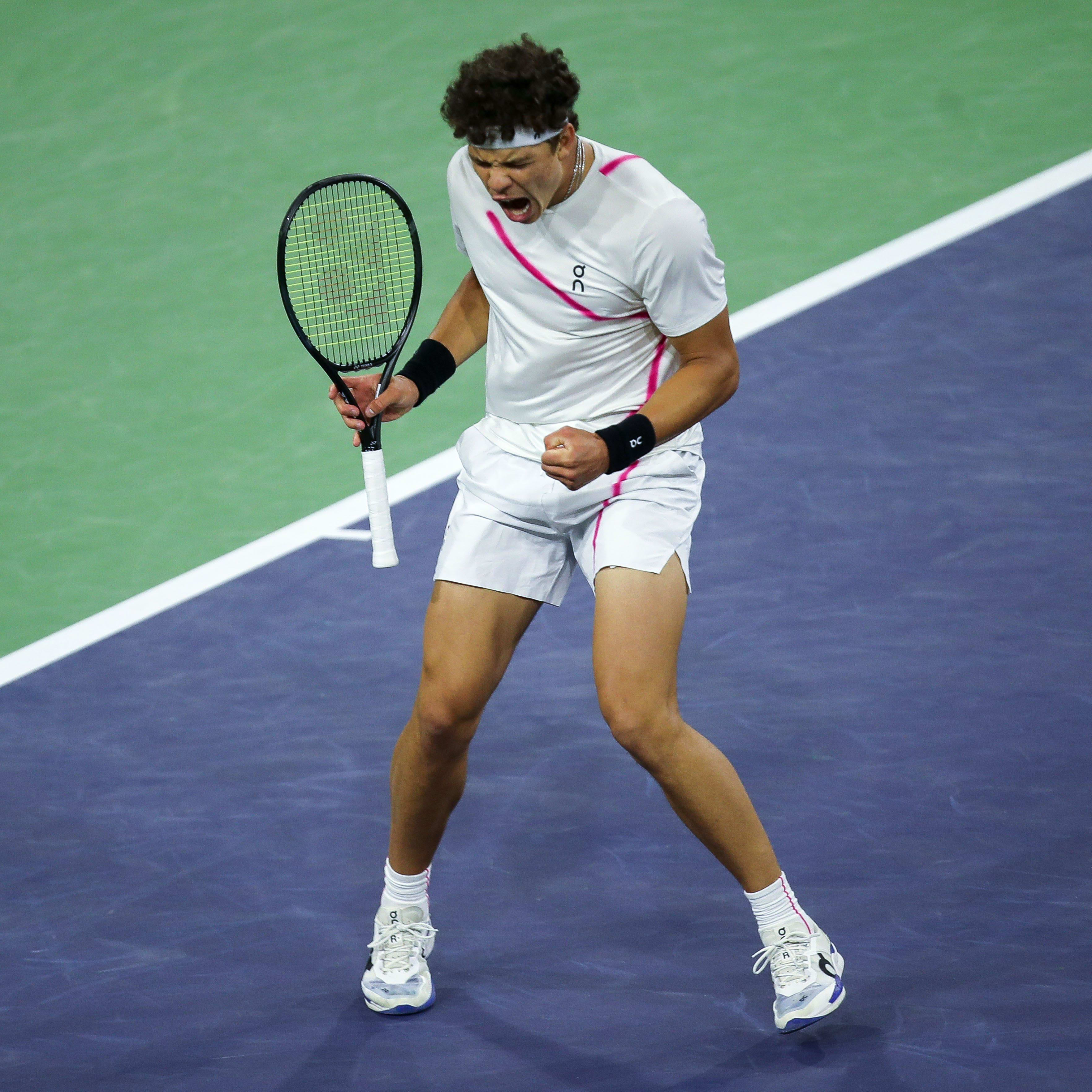 Ben Shelton celebrates during a tennis match.