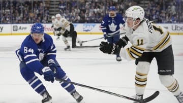 Apr 24, 2024; Toronto, Ontario, CAN; Boston Bruins forward Trent Frederic (11) scores on his shot as Toronto Maple Leafs forward David Kampf (64) looks on during the second period of game three of the first round of the 2024 Stanley Cup Playoffs at Scotiabank Arena. Mandatory Credit: John E. Sokolowski-USA TODAY Sports