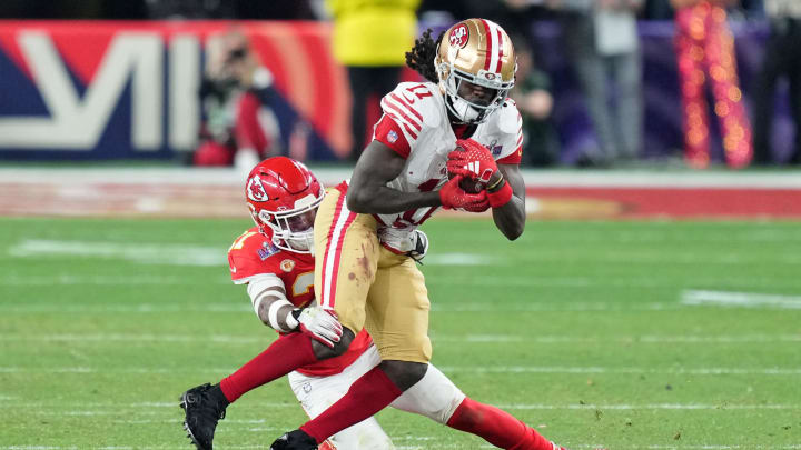 Feb 11, 2024; Paradise, Nevada, USA; Kansas City Chiefs safety Mike Edwards (21) tackles San Francisco 49ers wide receiver Brandon Aiyuk (11) during overtime of Super Bowl LVIII at Allegiant Stadium. 