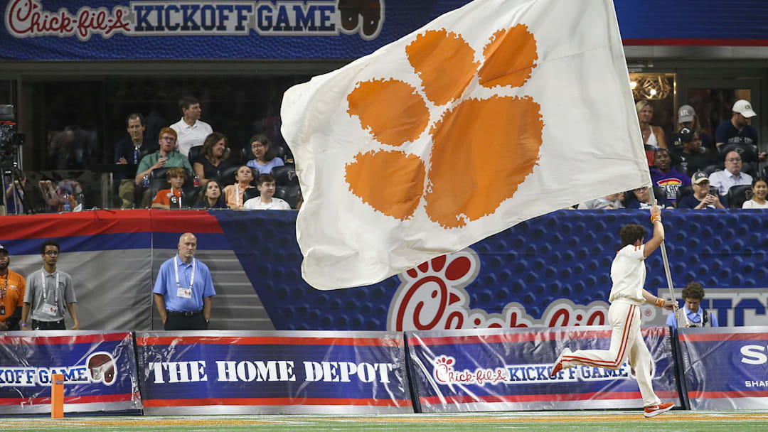 Sep 5, 2022; Atlanta, Georgia, USA; Clemson Tigers cheerleader runs a flag after a touchdown against the Georgia Tech Yellow Jackets in the second quarter at Mercedes-Benz Stadium. Mandatory Credit: Brett Davis-Imagn Images
