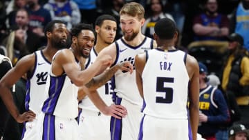 Feb 14, 2024; Denver, Colorado, USA; Sacramento Kings guard Malik Monk (0) and forward Domantas Sabonis (10) and guard De'Aaron Fox (5) react in the fourth quarter against the Denver Nuggets at Ball Arena. Mandatory Credit: Ron Chenoy-USA TODAY Sports